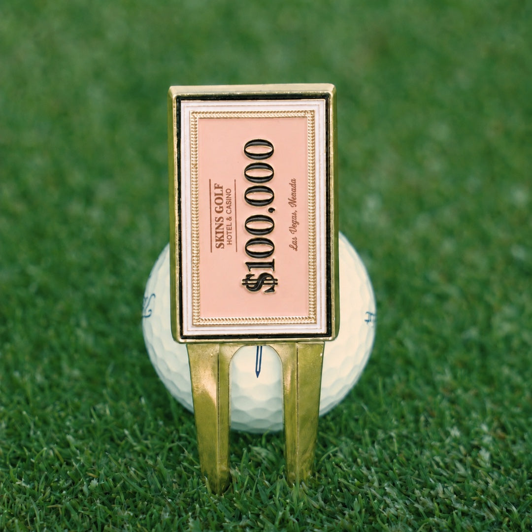 Golf ball with a $100,000 bill holder on a green grass background