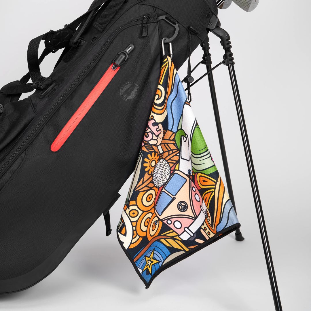 Golf towel with hippie design hanging on golf bag