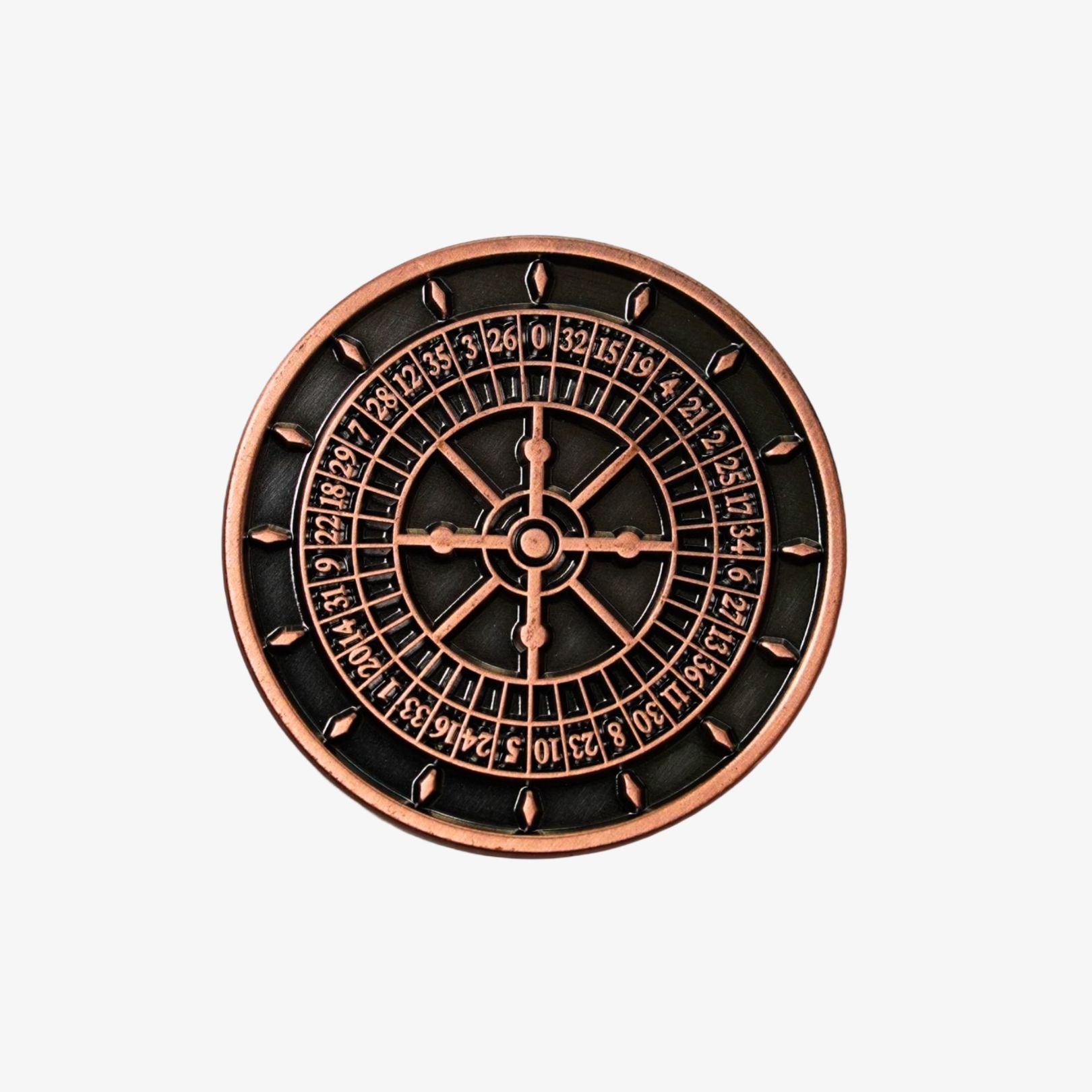 Decorative roulette wheel golf ball marker with copper border on a white background