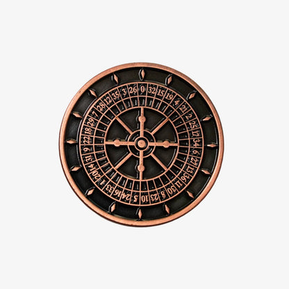 Decorative roulette wheel golf ball marker with copper border on a white background