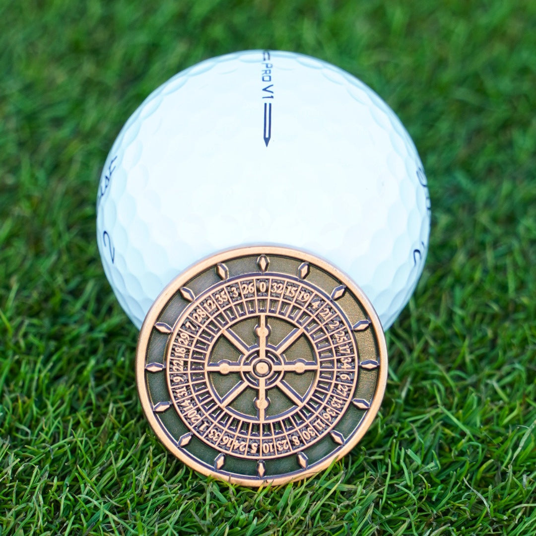 Golf ball with a roulette wheel on grass
