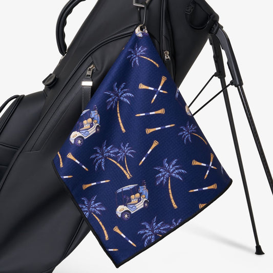 Golf towel with palm tree and golf cart pattern on a black golf bag