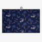 Navy blue towel with palm tree and golf cart pattern on a white background