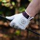 White leather golf glove with cool design holding club 