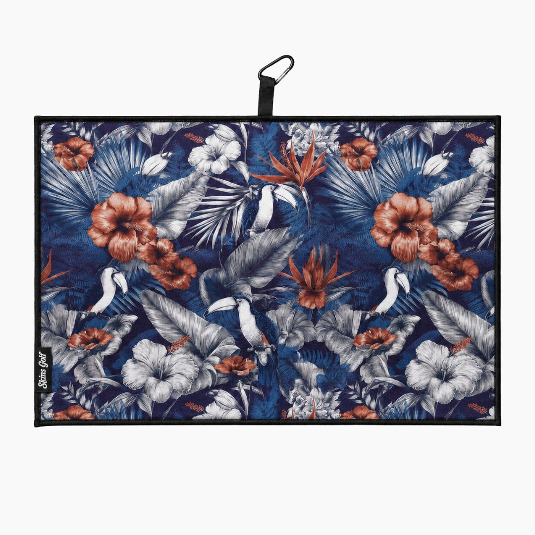Floral patterned towel with a black clip on a white background