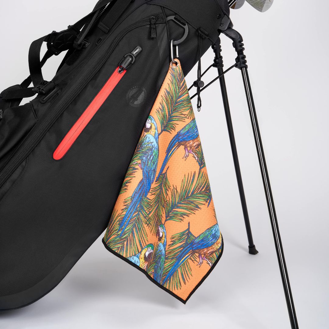 Tropical golf towel in orange on a golf bag