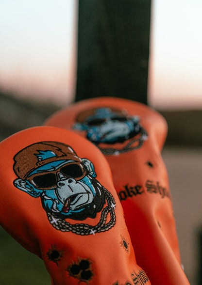 Close-up of orange golf headcover with gorilla design.