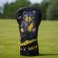 Golf club head cover with colorful design on a grassy background