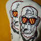 Two white golf headcovers with monkey designs wearing sunglasses on a yellow background