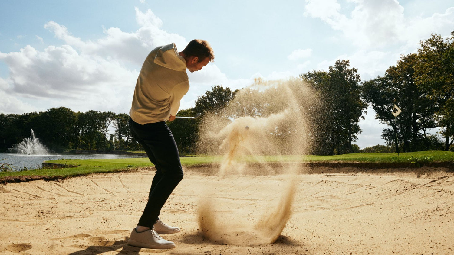 Golfer playing a bunker shot
