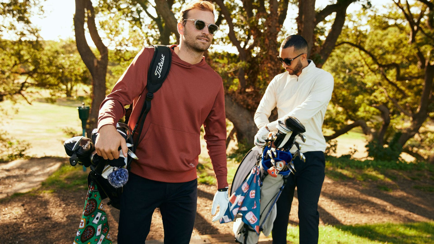Golfers wearing cool gear and carrying golf bags