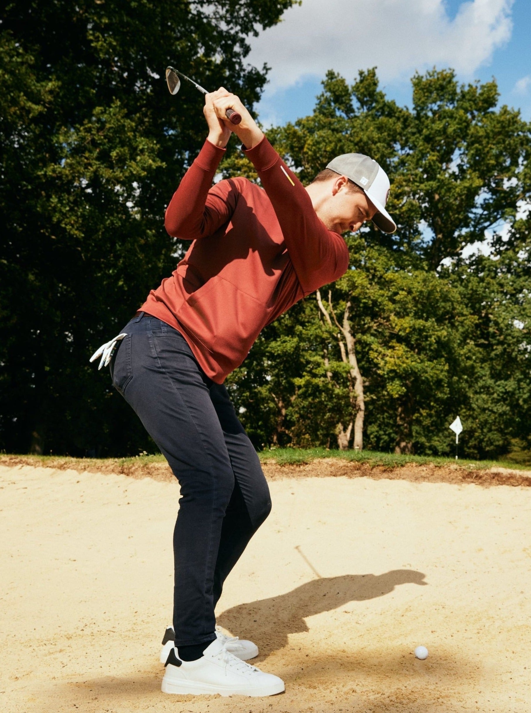Golfer taking bunker shot